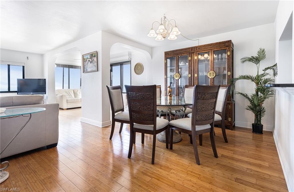 Dining area featuring a notable chandelier and hardwood / wood-style flooring