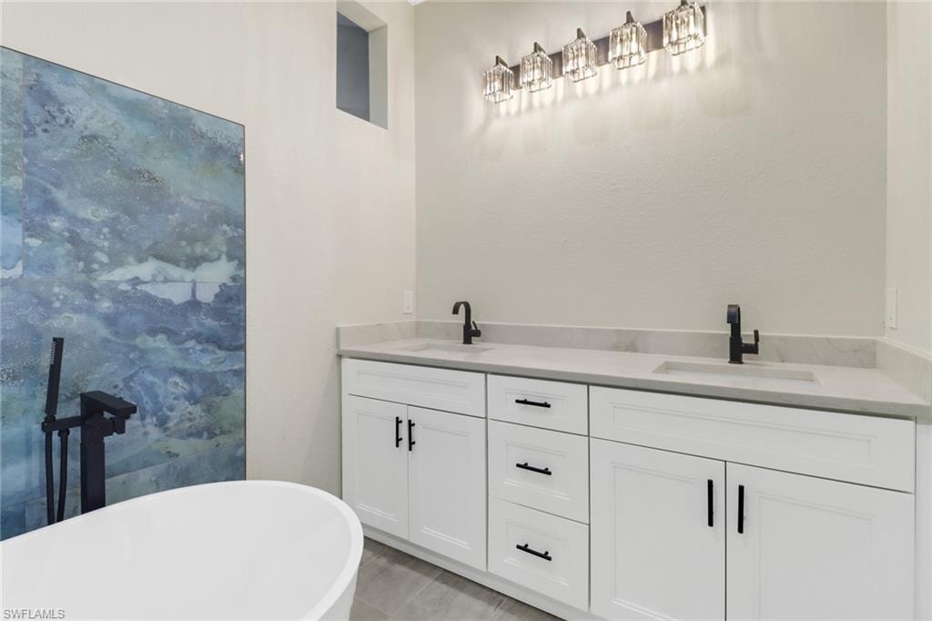 Bathroom featuring vanity and a washtub
