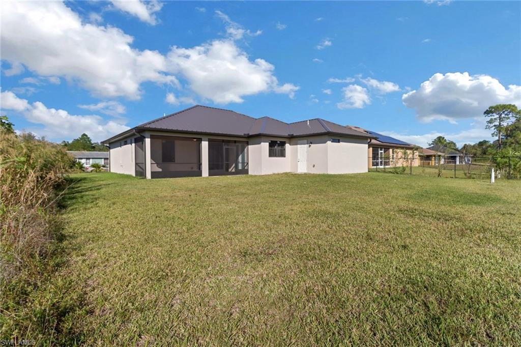 Rear view of property featuring a yard