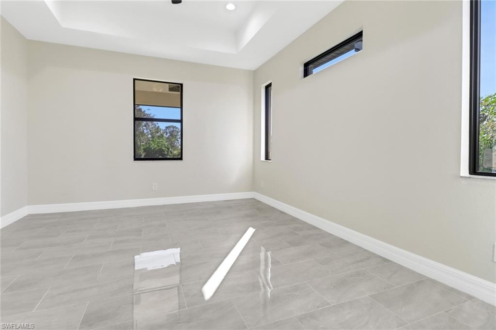 Unfurnished room featuring a raised ceiling