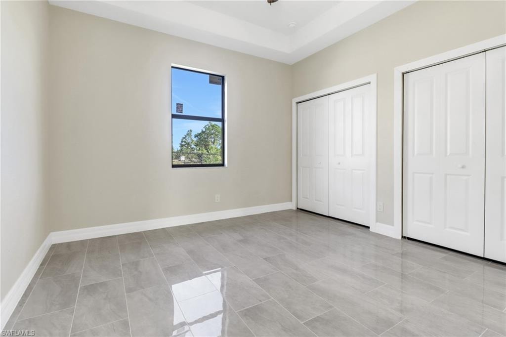 Unfurnished bedroom featuring two closets