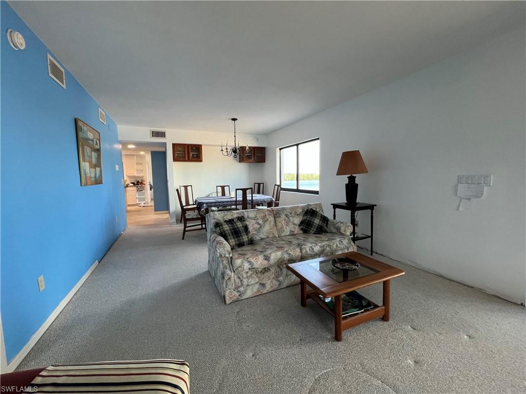 Living room featuring a chandelier and light colored carpet