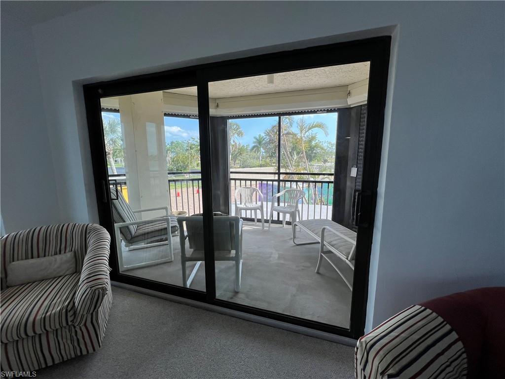 Doorway with carpet and a healthy amount of sunlight