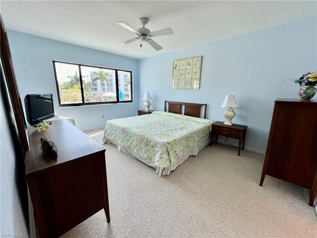 Bedroom featuring light carpet and ceiling fan