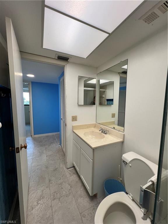 Bathroom with tile patterned floors, toilet, and vanity