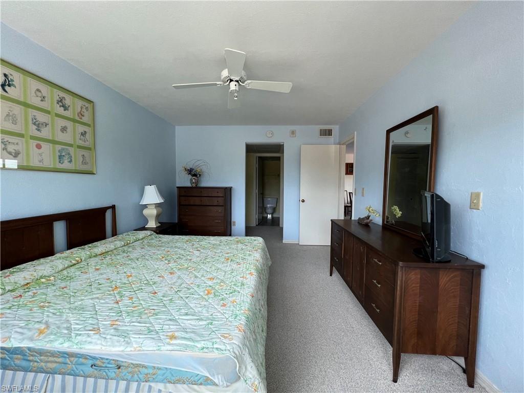 Carpeted bedroom with ceiling fan