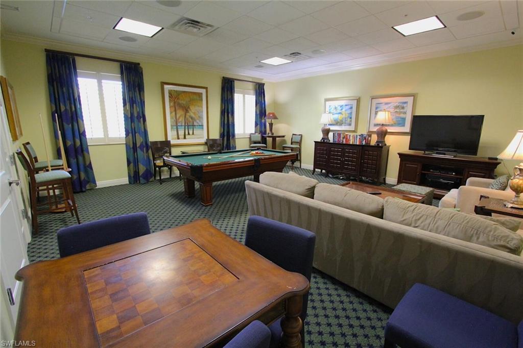 Billiards room featuring pool table, carpet floors, a small library and games