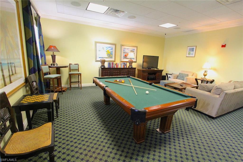 Billiards room featuring pool table, carpet floors, a small library and games
