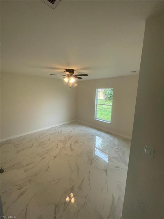 Spare room with ceiling fan