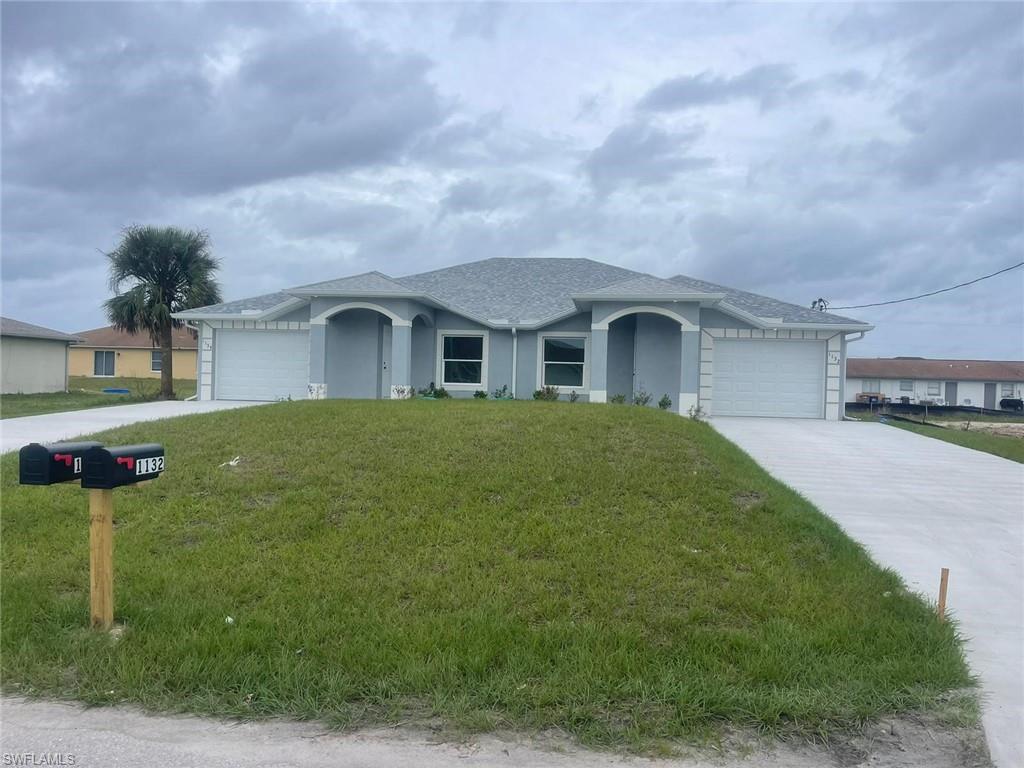 Ranch-style home featuring a garage and a front yard