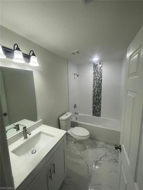 Full bathroom with shower / bath combo, vanity, and toilet
