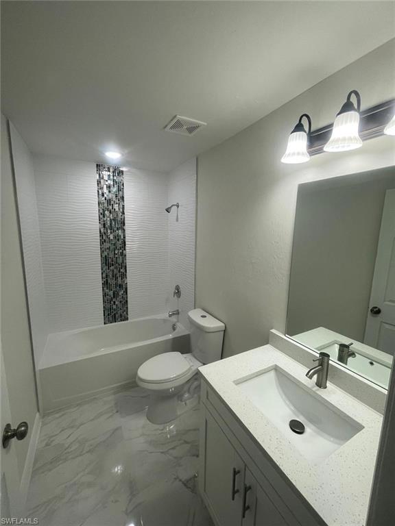 Full bathroom featuring shower / tub combo with curtain, vanity, and toilet