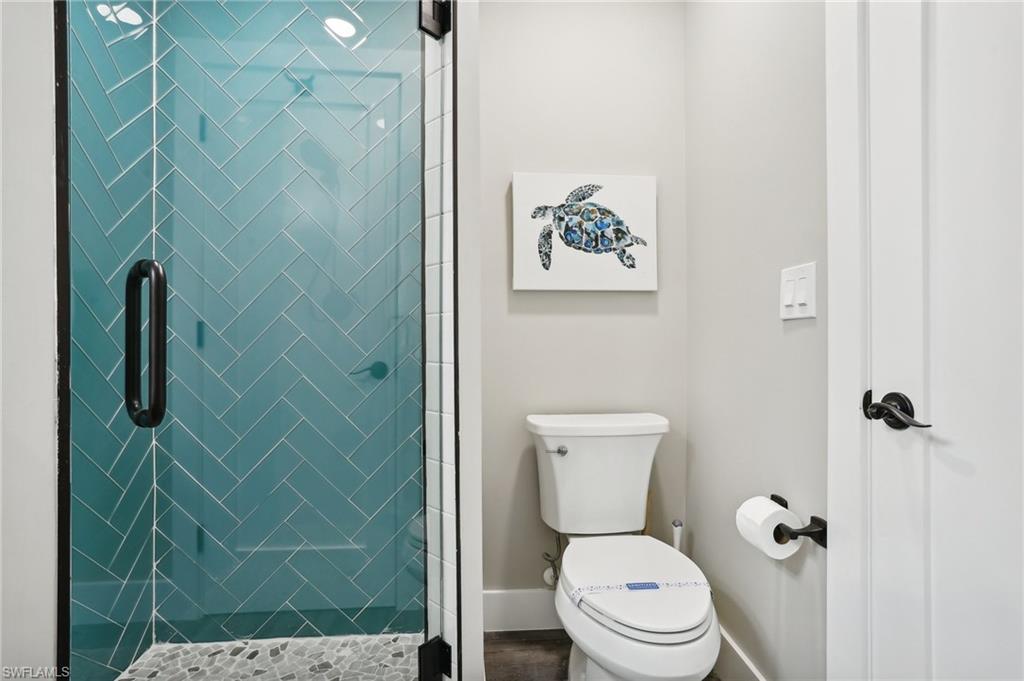 Bathroom featuring walk in shower and toilet