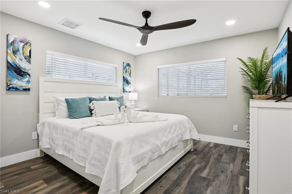 Bedroom with dark wood-type flooring and ceiling fan
