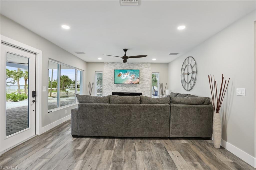Living room with ceiling fan and wood-type flooring
