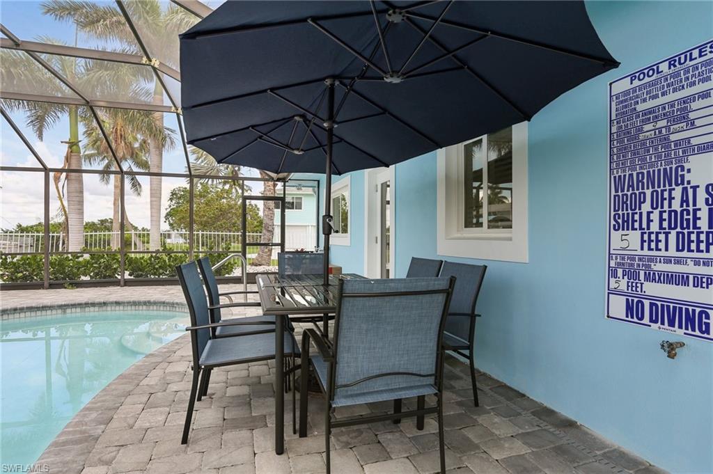 View of patio featuring a fenced in pool and glass enclosure