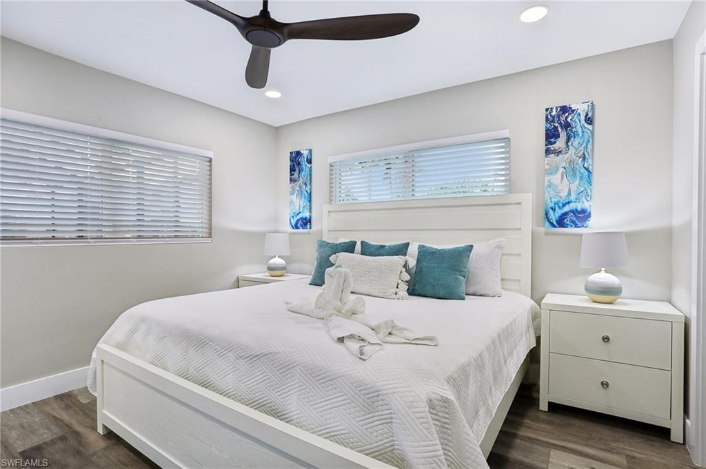 Bedroom with dark hardwood / wood-style floors and ceiling fan