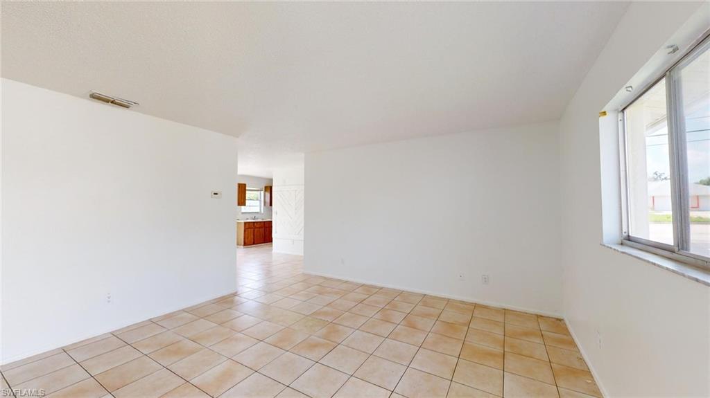 Empty room with light tile patterned floors