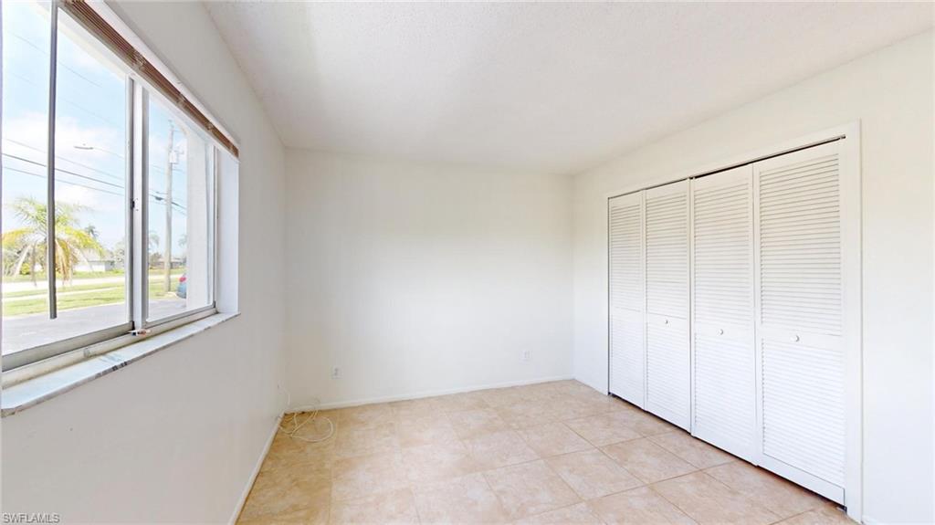 Unfurnished bedroom featuring a closet and light tile patterned floors