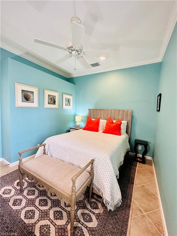 Bedroom featuring ornamental molding, light tile patterned floors, and ceiling fan