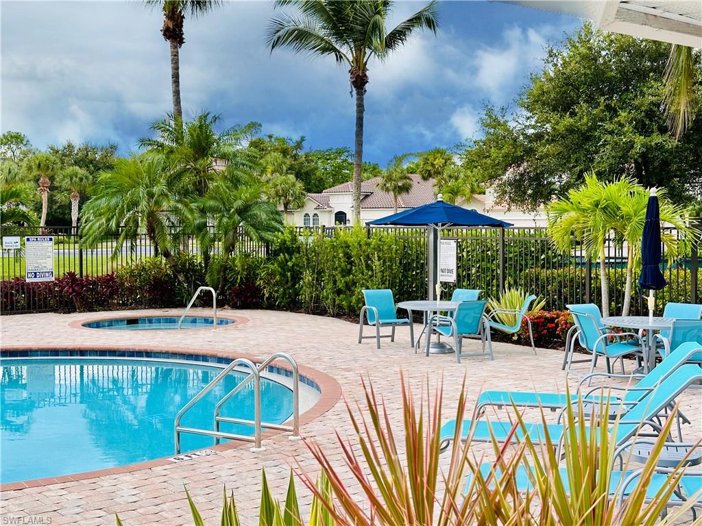 Clubhouse swimming pool with a hot tub and a patio area