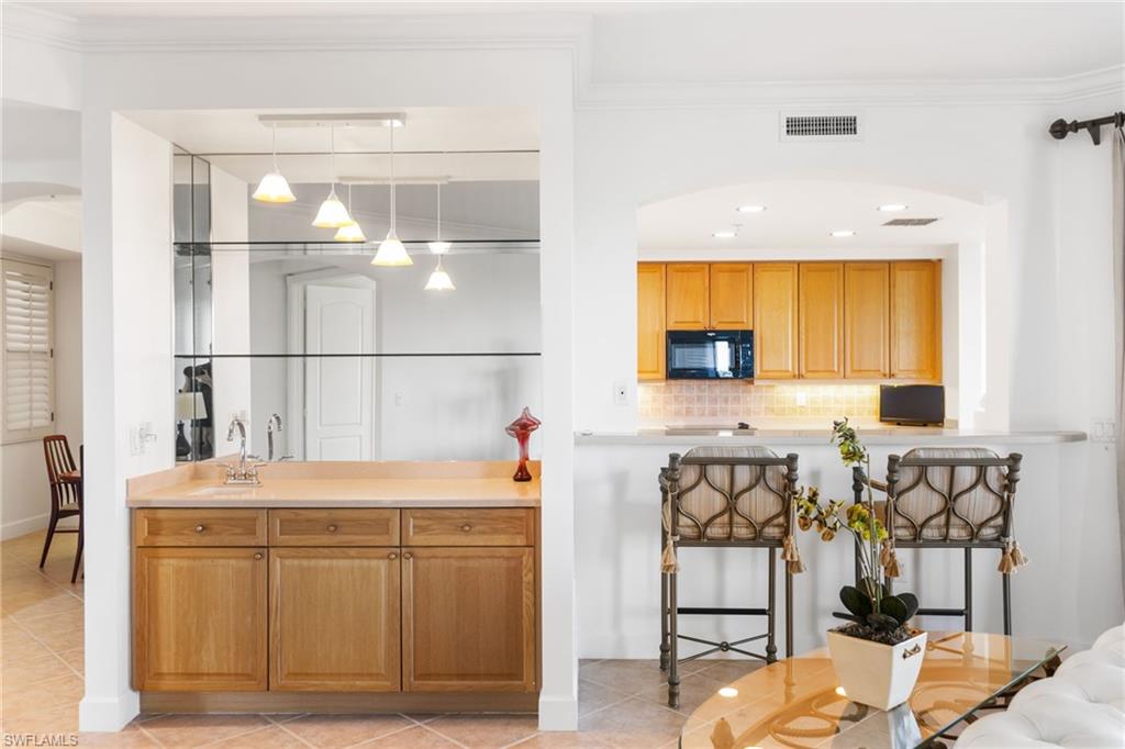 Your wet bar has a sink and mirrored back and shelving.  Pass thru window makes it easy for entertaing!