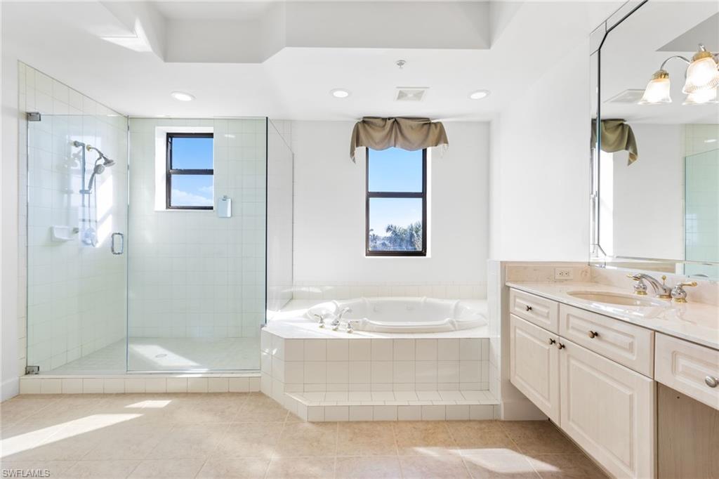 Seamless glass enclosure in your oversized walk in shower. Separate soaking tub!