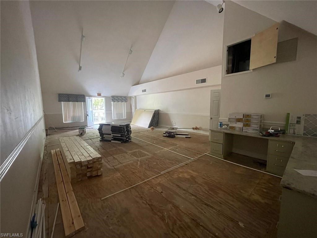 Unfurnished living room featuring dark wood finished floors