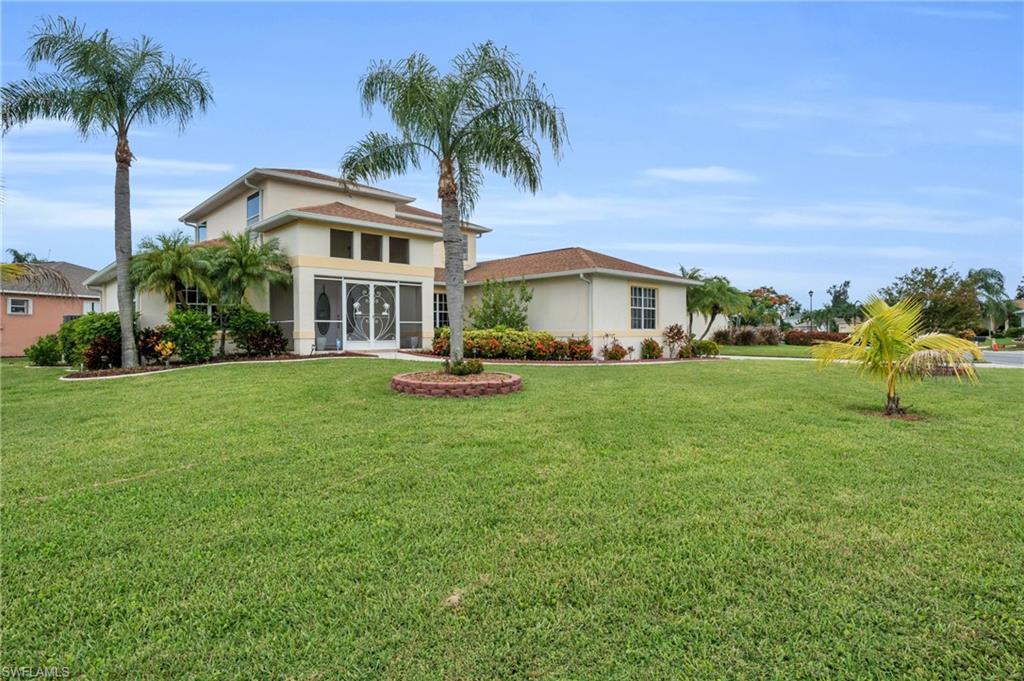 View of front of property featuring a sunroom and a front yard