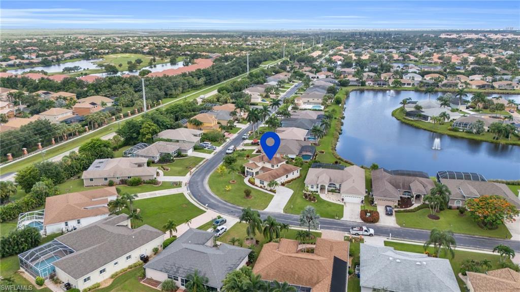 Birds eye view of property with a water view