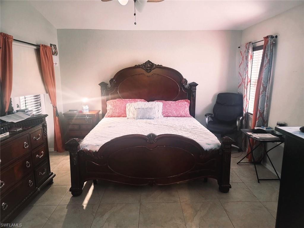 Tiled bedroom with ceiling fan