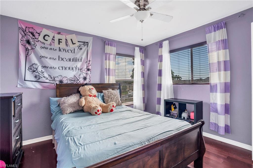 Bedroom featuring ceiling fan and dark hardwood / wood-style floors