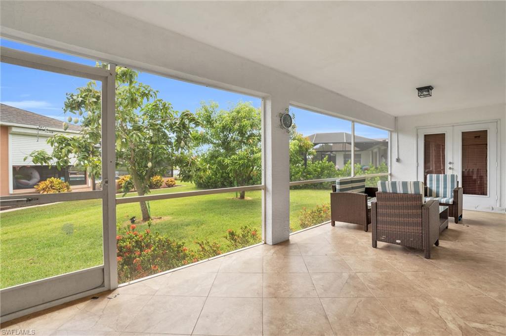Sunroom / solarium featuring french doors and a healthy amount of sunlight