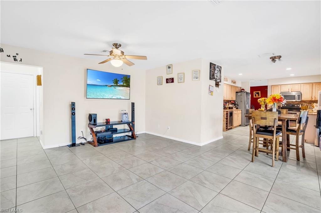 Dining space featuring ceiling fan and light tile patterned floors