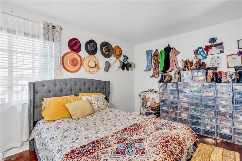 Bedroom with multiple windows and hardwood / wood-style flooring