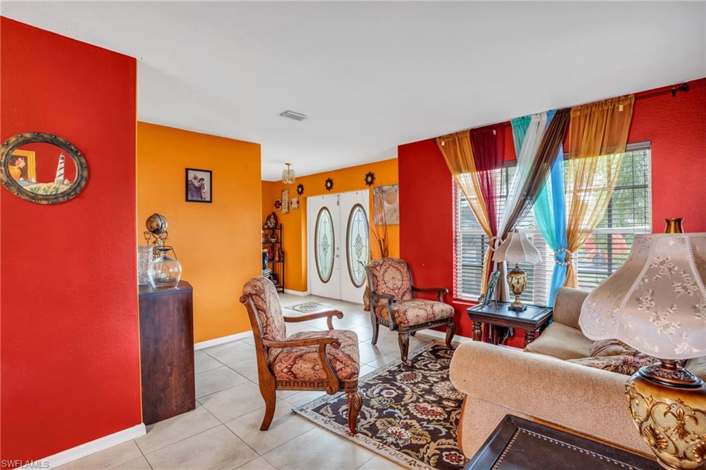 Living room with light tile patterned flooring