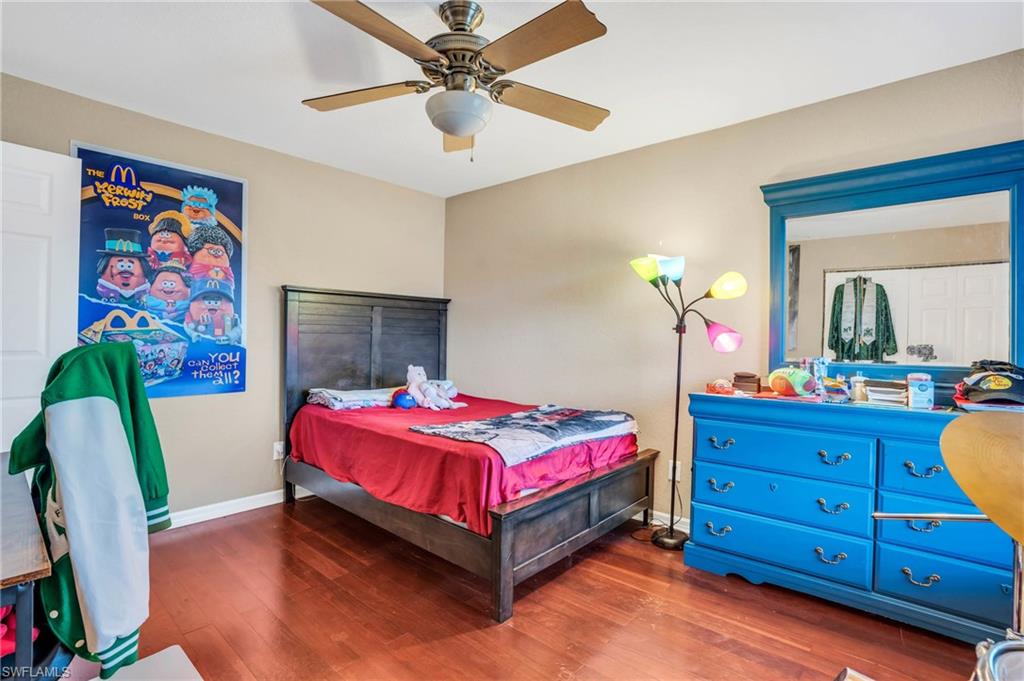 Bedroom featuring dark hardwood / wood-style floors and ceiling fan