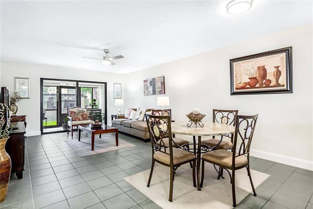 Tiled dining room featuring ceiling fan