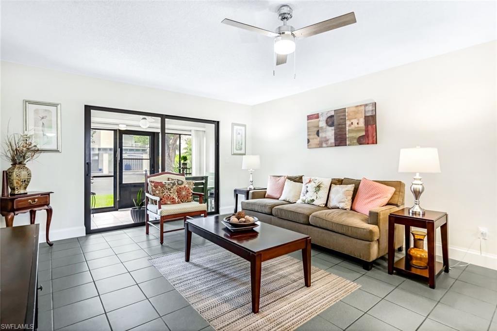 Living room featuring ceiling fan and tile patterned flooring
