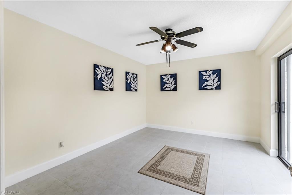 Unfurnished room with ceiling fan and light tile patterned flooring