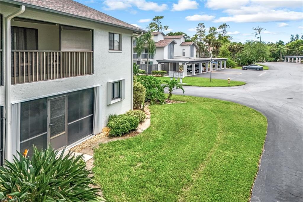 View of property's community with a lawn