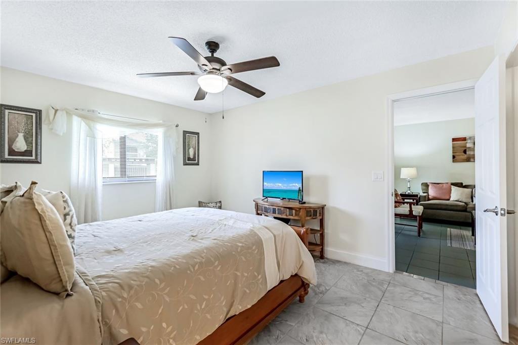 Tiled bedroom with ceiling fan