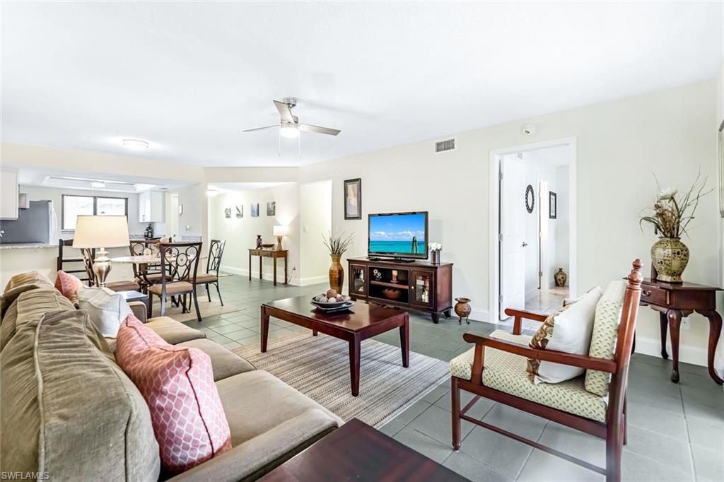 Tiled living room featuring ceiling fan