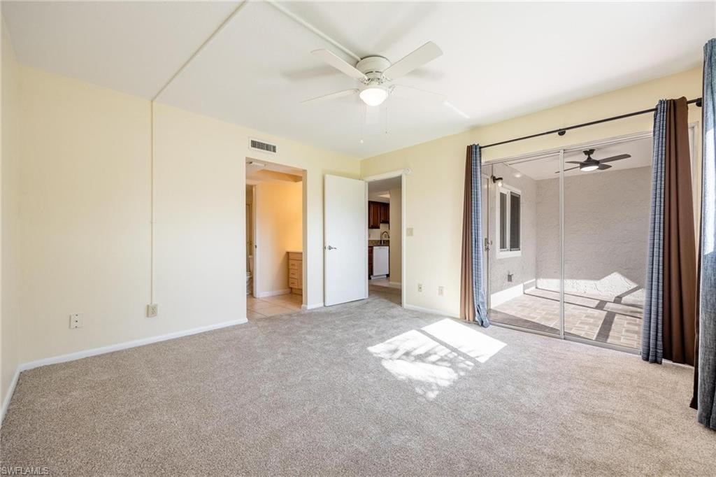 Primary bedroom with sliding glass doors to front lanai