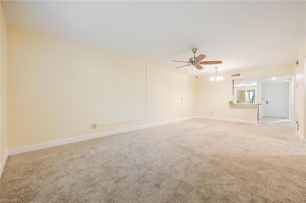 Living room featuring ceiling fan and light colored carpet