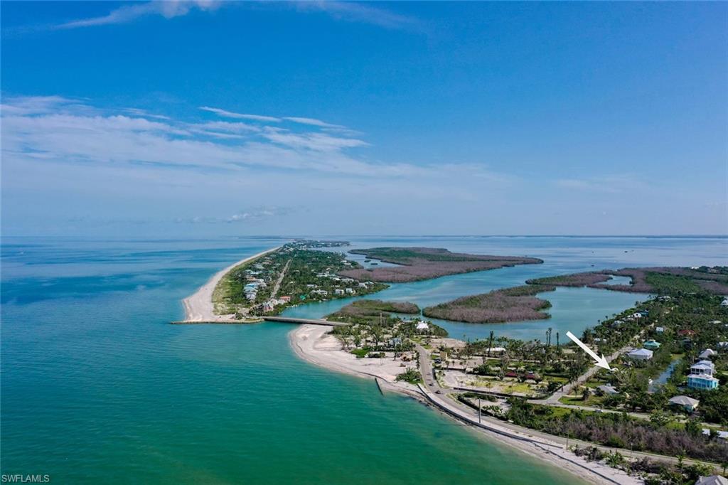 Bird's eye view with a water view and a view of the beach
