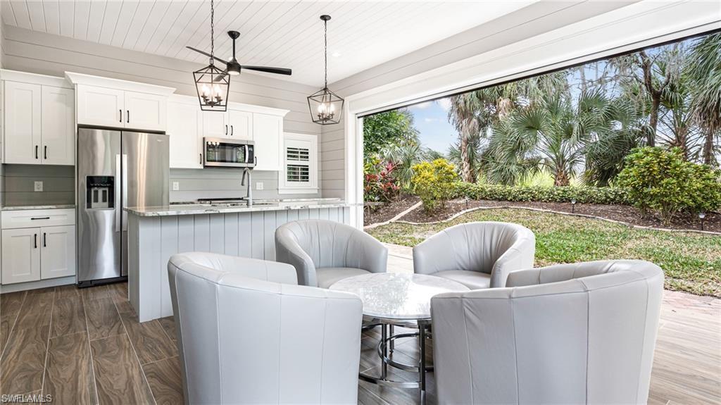 Kitchen and seating area, clear electric screens over-looking preserve