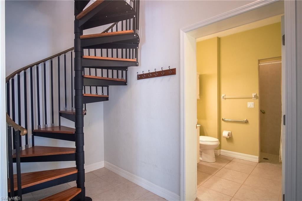 Downstairs primary bathroom & spiral staircase