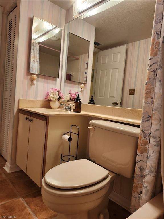 Bathroom with tile patterned flooring, vanity, a shower with curtain, and toilet