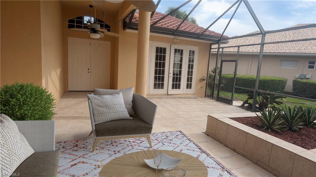 View of patio featuring french doors, a lanai, and ceiling fan